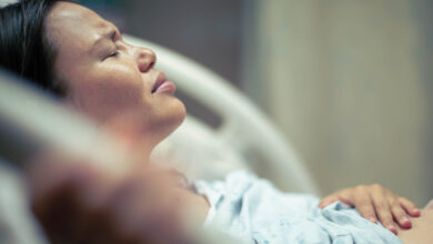 A sick woman patient in bed at the hospital suffering from pain. Contractions and childbirth.