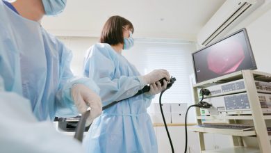 Closeup low angle view asian physician colonoscopy to patient in the clinic with nurse assistance - cancer related examinations