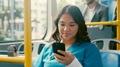 Bus, nurse and woman with smartphone, travel and communication with public transport. Person, healthcare professional and employee with cellphone, morning commute and texting with social media or app