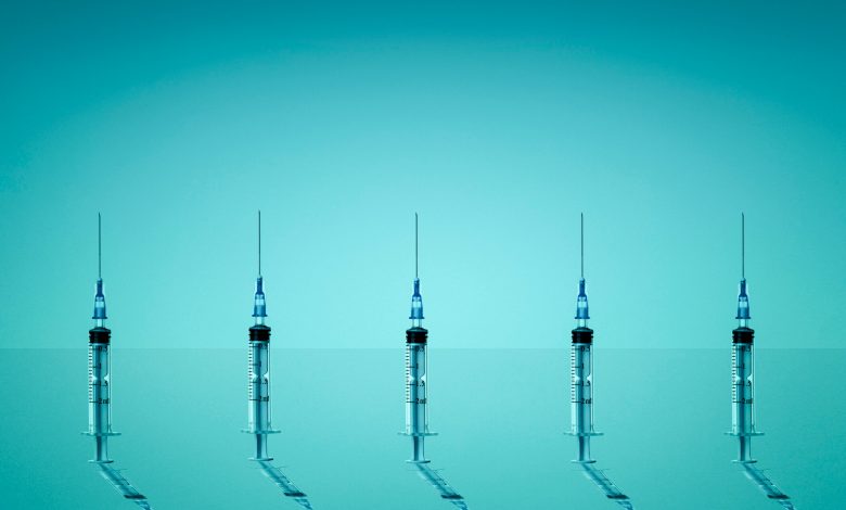 Group of syringes photographed on blue background