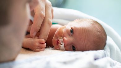Father taking care of his premature baby doing skin to skin at hospital. Color and horizontal photo was taken in Quebec Canada.