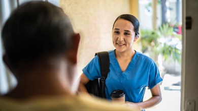 Mid adult nurse arriving at client home