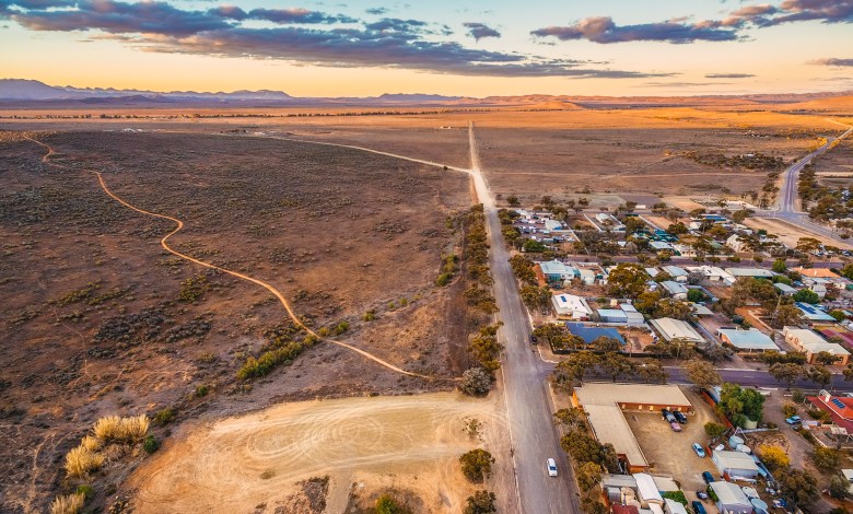 Rural road passing through Hawker - town in South Australia at sunset
