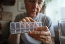Man at home with pills organizer
