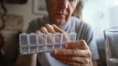 Man at home with pills organizer