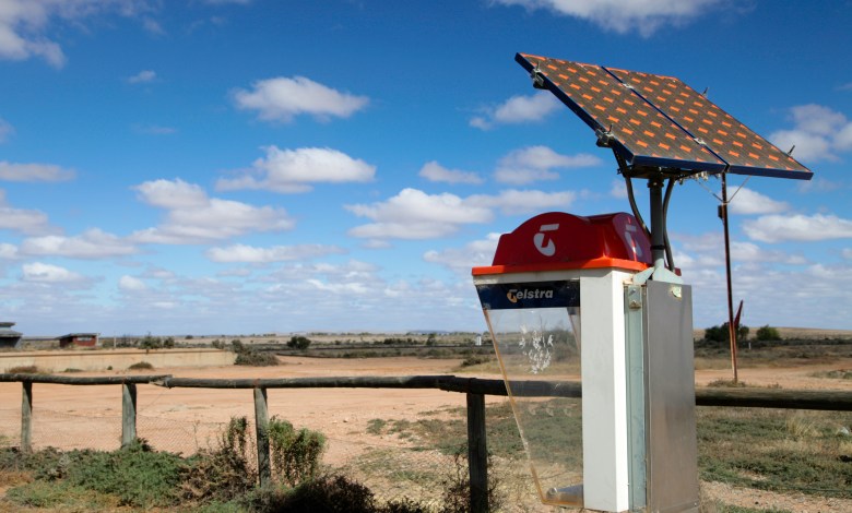 "South Australia, Australia - 12th, May 2012 : Australian Telstra public phone in the outback town of Olary with a solar panel, some areas of Australia mobile phones have no signal."