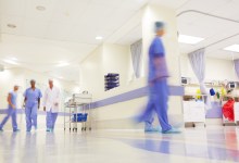 Blurred shot of doctors working in a busy hospital corridor