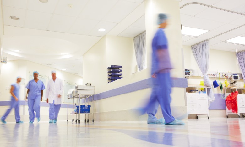 Blurred shot of doctors working in a busy hospital corridor