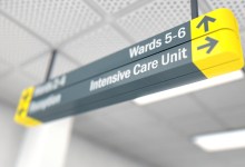 A ceiling mounted hospital directional sign highlighting the way towards the intensive care unit - 3D render
