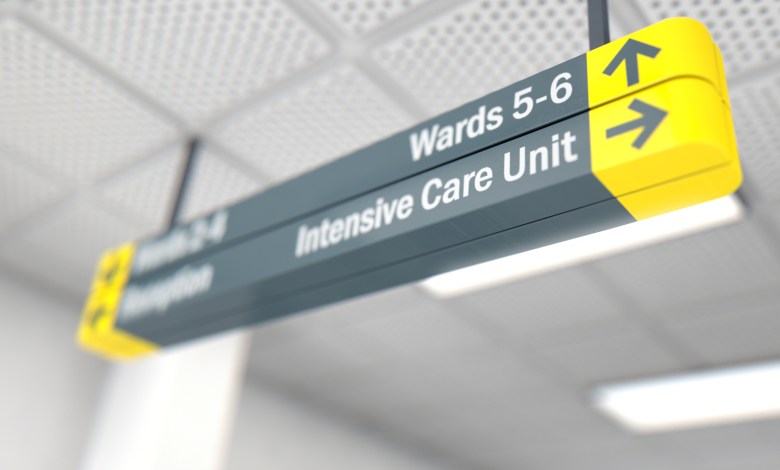 A ceiling mounted hospital directional sign highlighting the way towards the intensive care unit - 3D render