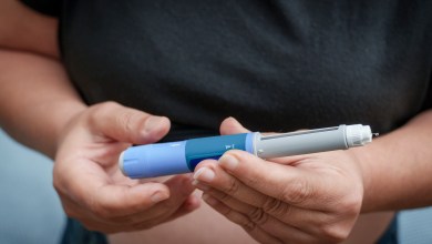 Person's hands holding an insulin pen for diabetes treatment
