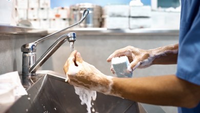 Cropped image of veterinarian washing hands with soap at sink. Close-up of surgeon preparing for surgery. He is in operating room.